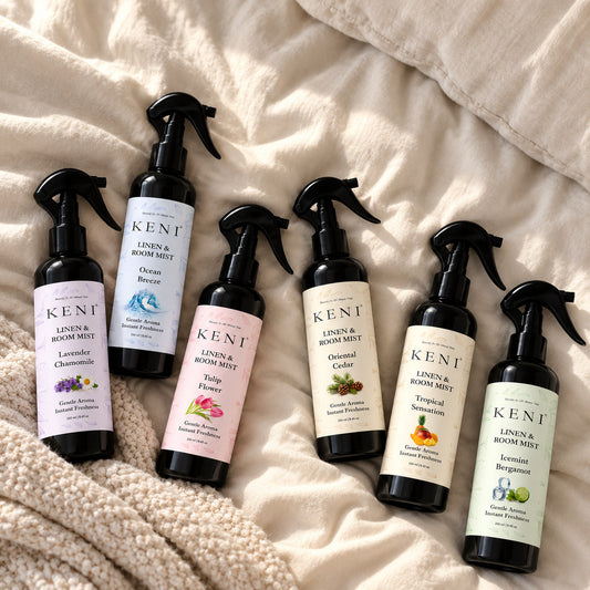 Six KENI Cosmetics linen and room mist scents in black spray bottles, available in Lebanon